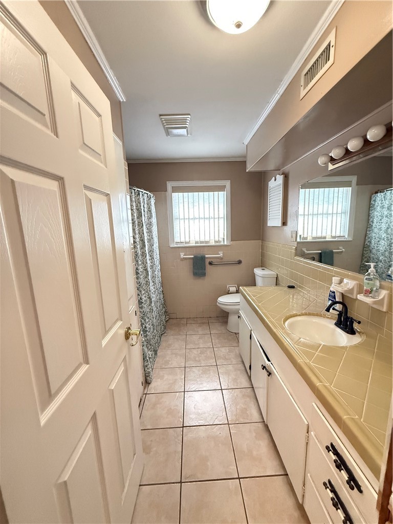 1603 Pena Street Alice, TX 78332 - Photo 13 of 15 a large white kitchen with a sink a large window and a stove