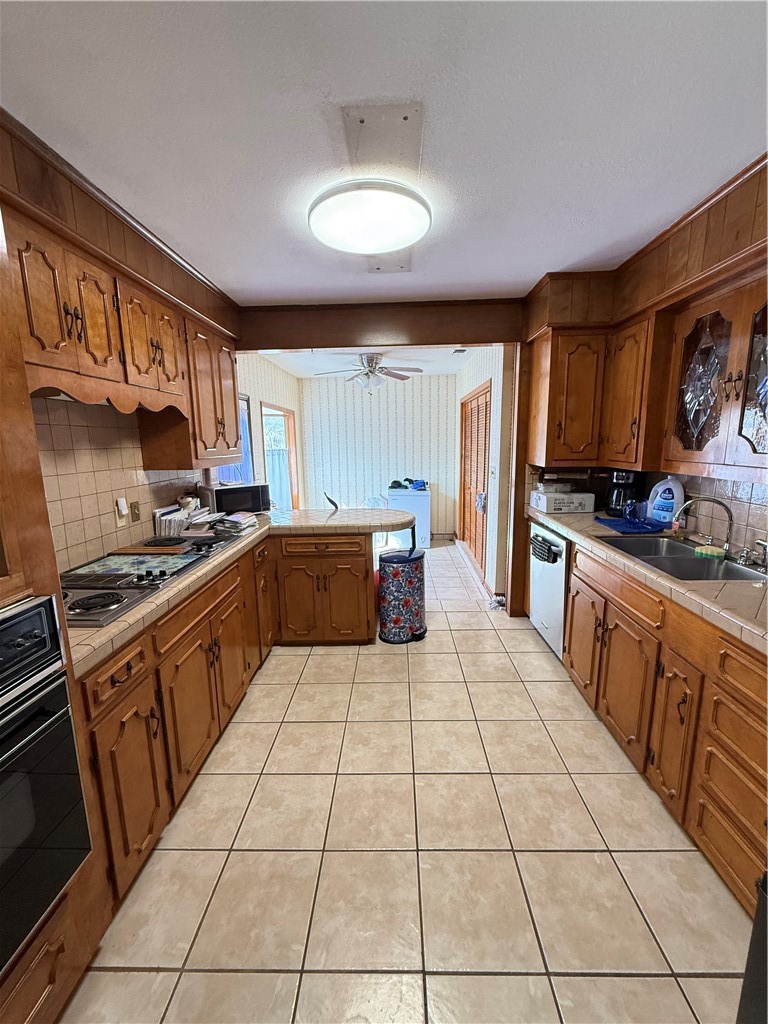 1603 Pena Street Alice, TX 78332 - Photo 5 of 15 a kitchen with stainless steel appliances granite countertop a stove a sink and a microwave