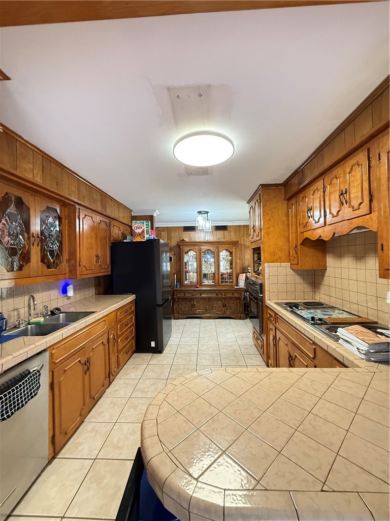 1603 Pena Street Alice, TX 78332 - Photo 7 of 15 a kitchen with stainless steel appliances granite countertop a stove a sink and a refrigerator