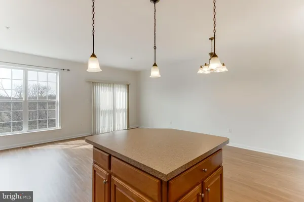 a view of a room with wooden floor and window