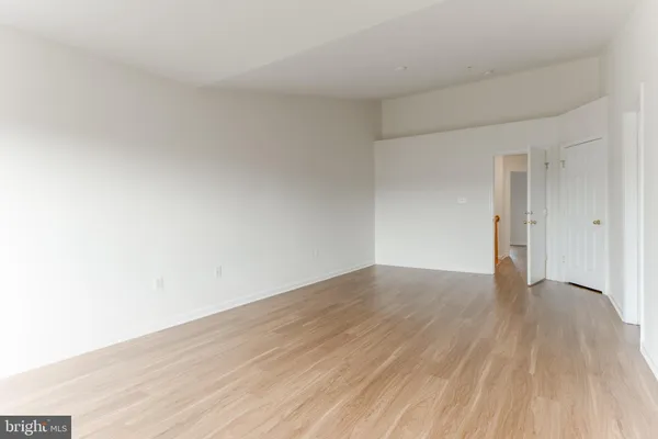 a view of an empty room and wooden floor