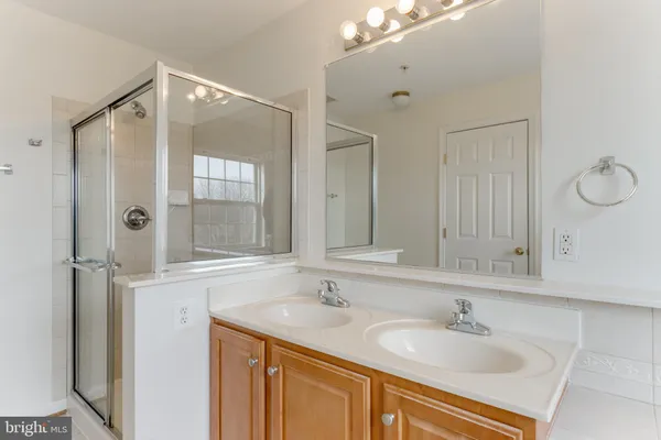 a bathroom with a sink double vanity and a mirror
