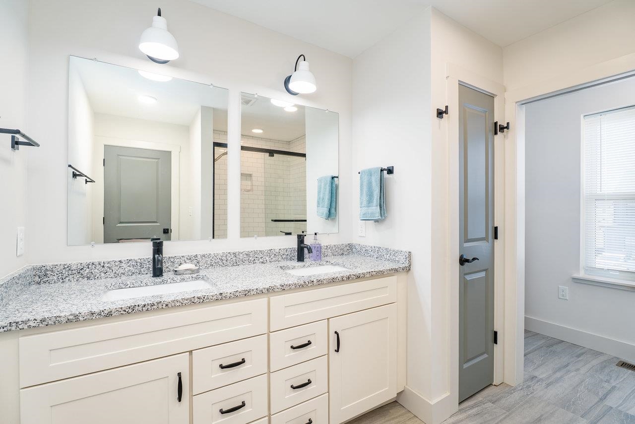 30 Field Court Bridgewater, VA 22812 - Photo 41 of 65 a bathroom with a granite countertop sink and a mirror