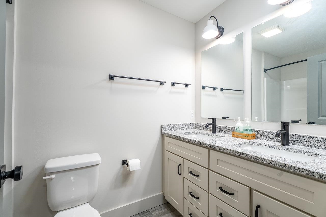 30 Field Court Bridgewater, VA 22812 - Photo 53 of 65 a bathroom with a granite countertop sink a toilet and mirror