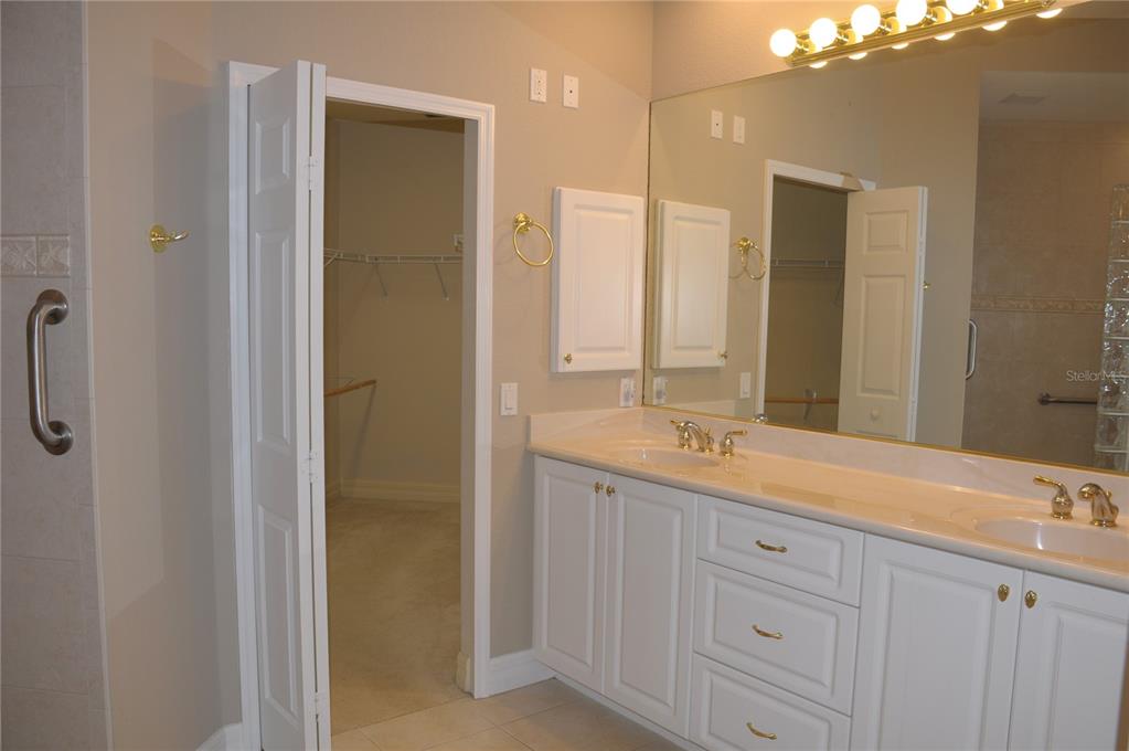 3959 San Rocco Court, Unit 911 Punta Gorda, FL 33950 - Photo 29 of 85 a bathroom with a double vanity sink and mirror