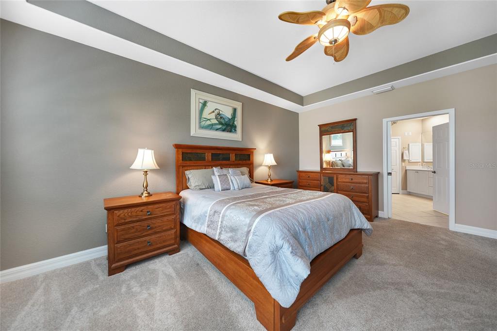 3959 San Rocco Court, Unit 911 Punta Gorda, FL 33950 - Photo 60 of 85 a bedroom with a bed dresser and wooden floor