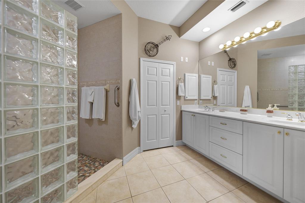 3959 San Rocco Court, Unit 911 Punta Gorda, FL 33950 - Photo 62 of 85 a spacious bathroom with a granite countertop sink a mirror and a shower