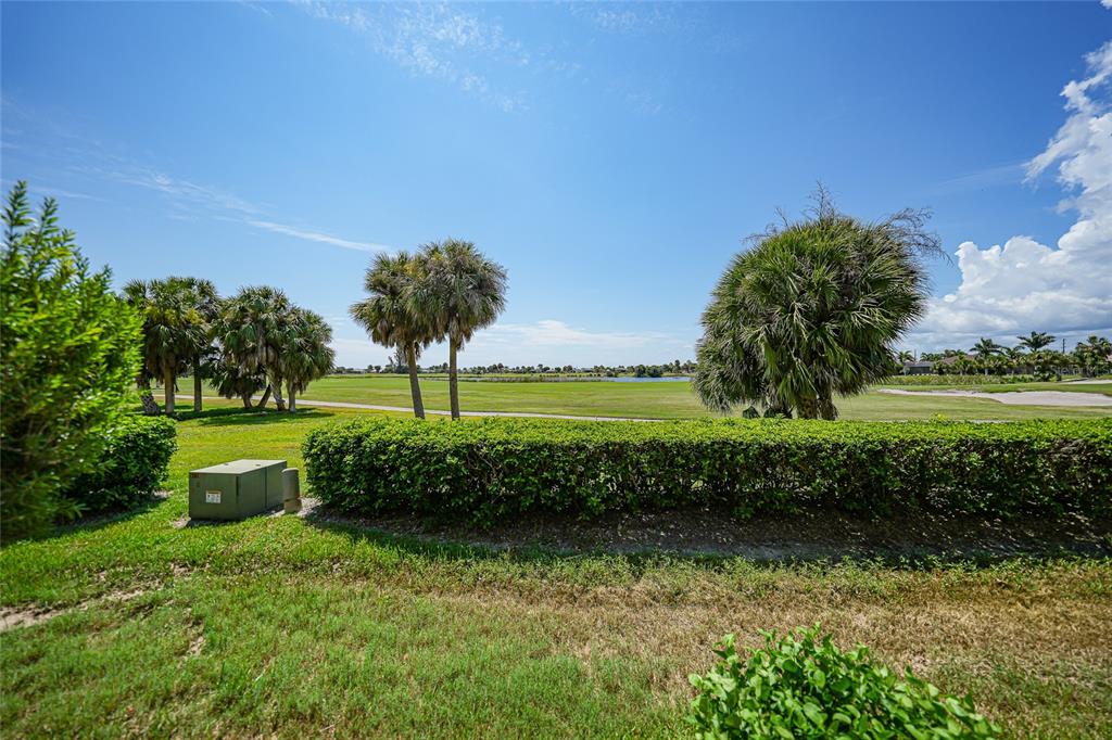 3959 San Rocco Court, Unit 911 Punta Gorda, FL 33950 - Photo 76 of 85 a view of a garden with a building in the background