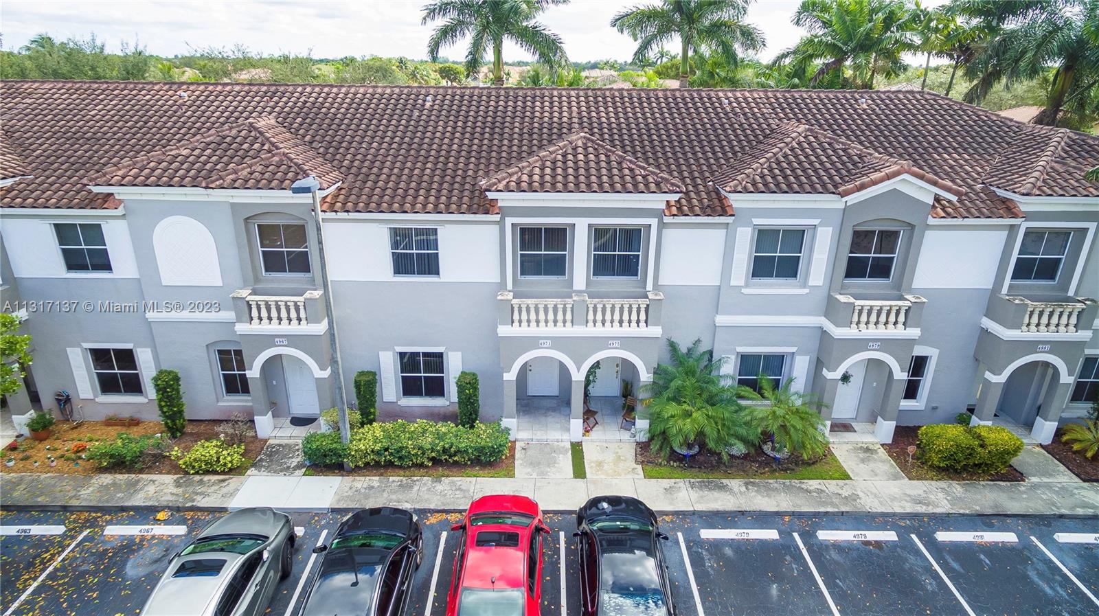 4971 Southwest 140th Terrace, Unit 6 Miramar, FL 33027 - Photo 1 of 24 a front view of a house with garden