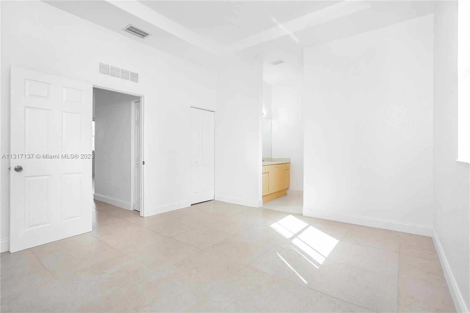 4971 Southwest 140th Terrace, Unit 6 Miramar, FL 33027 - Photo 11 of 24 an empty room with windows