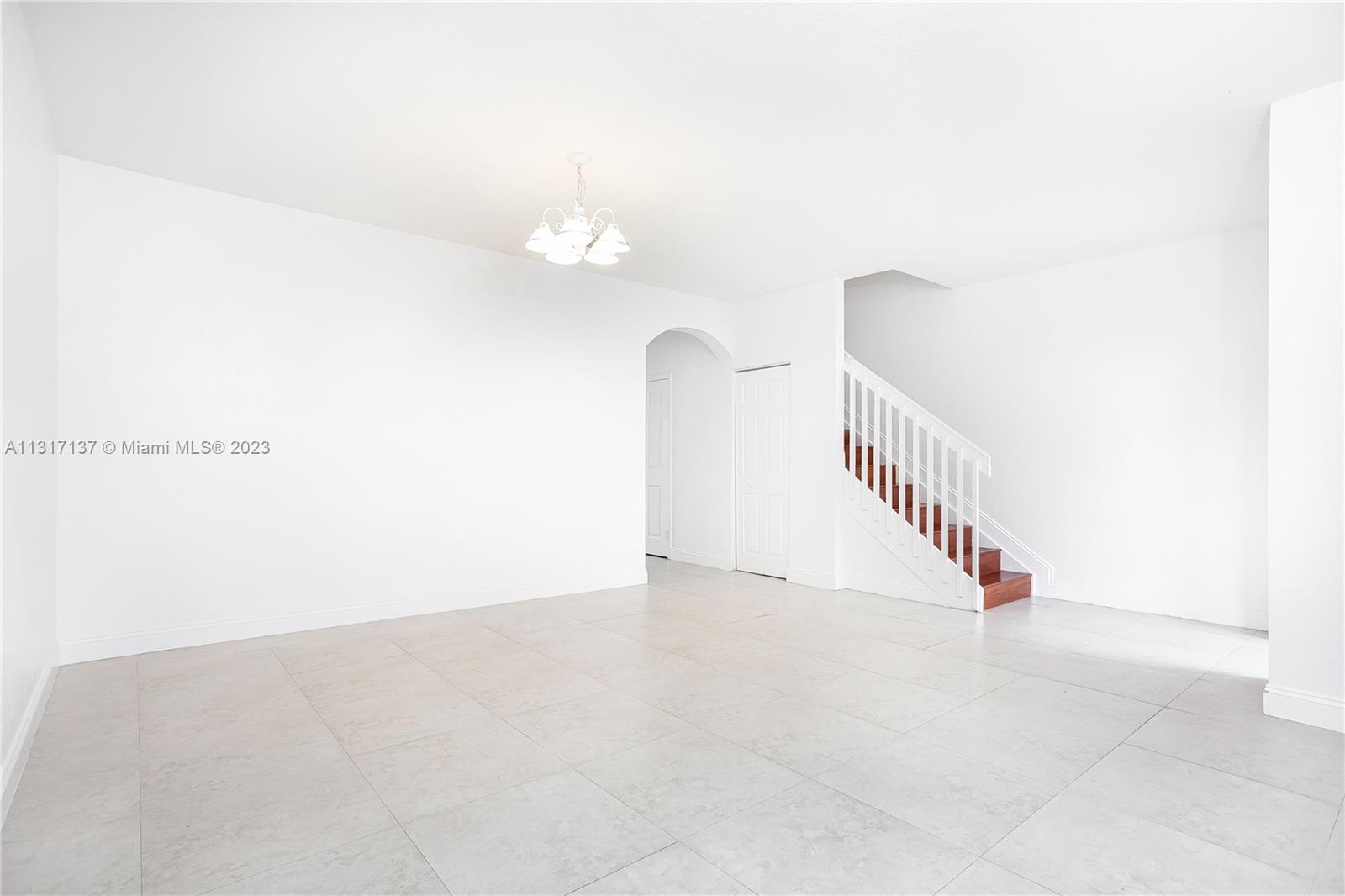 4971 Southwest 140th Terrace, Unit 6 Miramar, FL 33027 - Photo 4 of 24 a view of a room with stairs and white walls