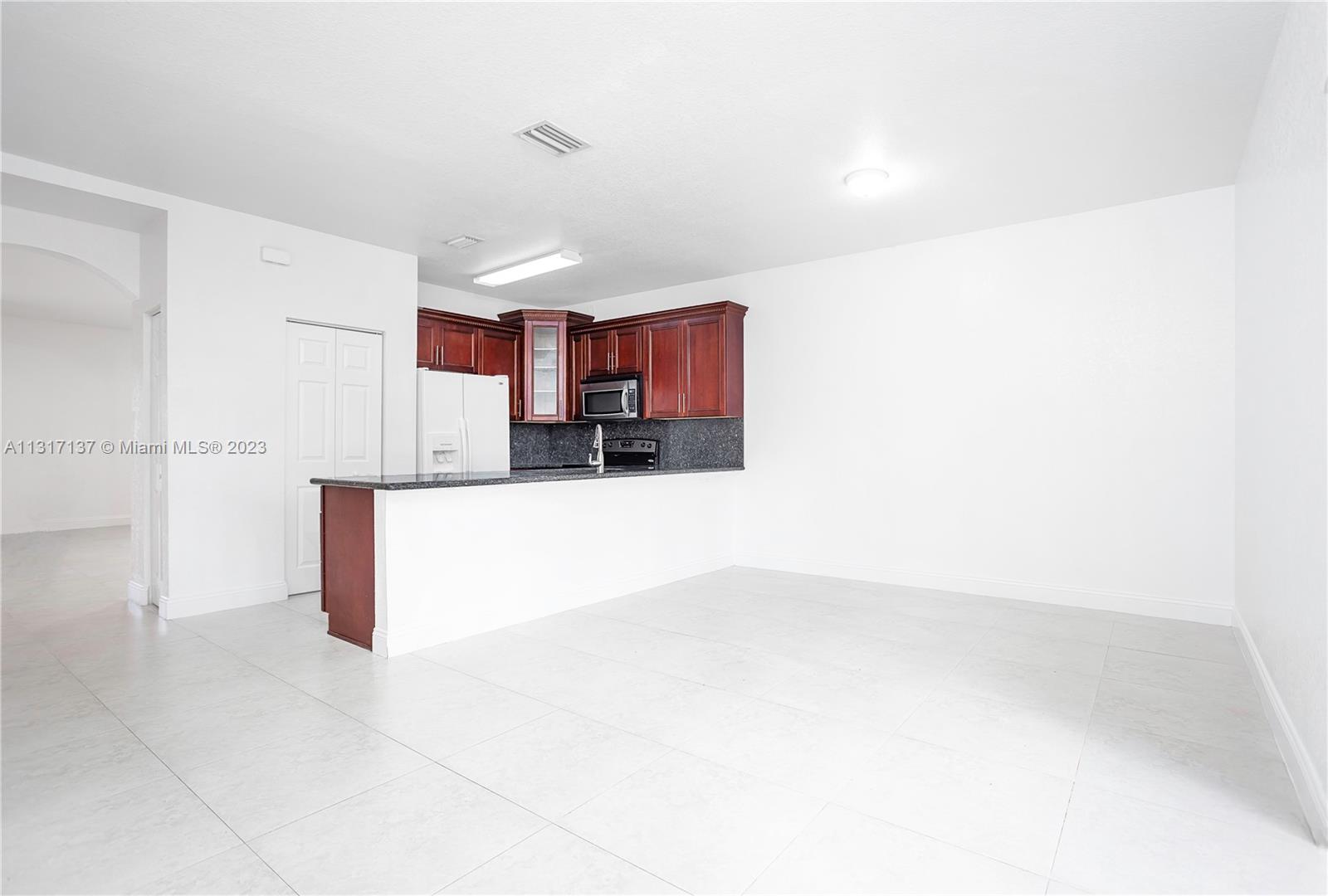 4971 Southwest 140th Terrace, Unit 6 Miramar, FL 33027 - Photo 6 of 24 a view of kitchen and kitchen with a sink