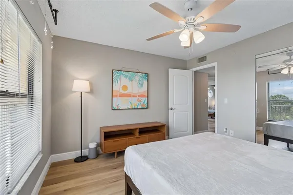 a view of a swimming pool and lounge chairs in back yard of the house
