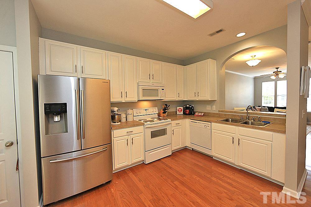 4532 Sugarbend Way Raleigh, NC 27606 - Photo 4 of 14 Expansive Kitchen. Stainless Refrigerator Conveys ! Kitchen Opens to Dining/Living Area. Great For Entertaining !