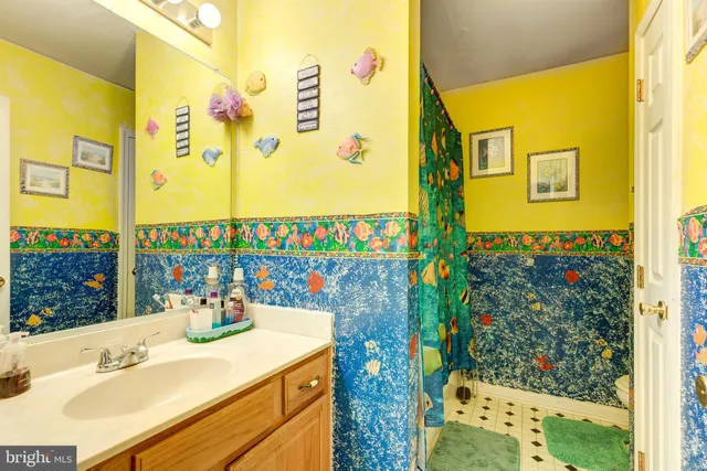 a bathroom with a sink mirror and a shower