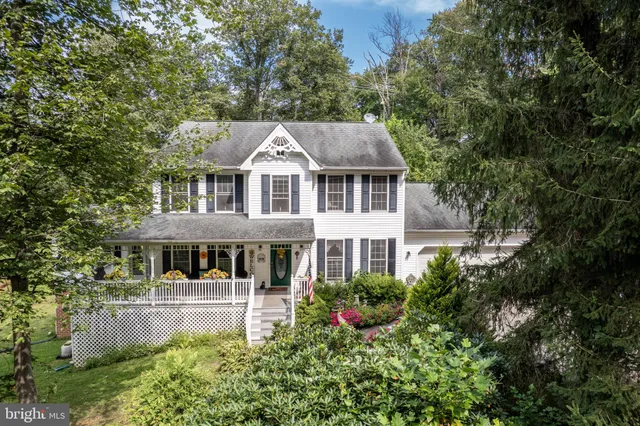 a front view of a house with a yard table and chairs
