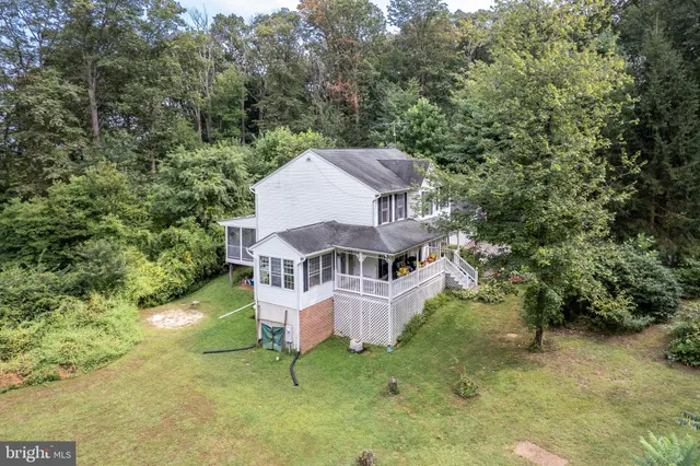 an aerial view of a house with swimming pool and sitting area