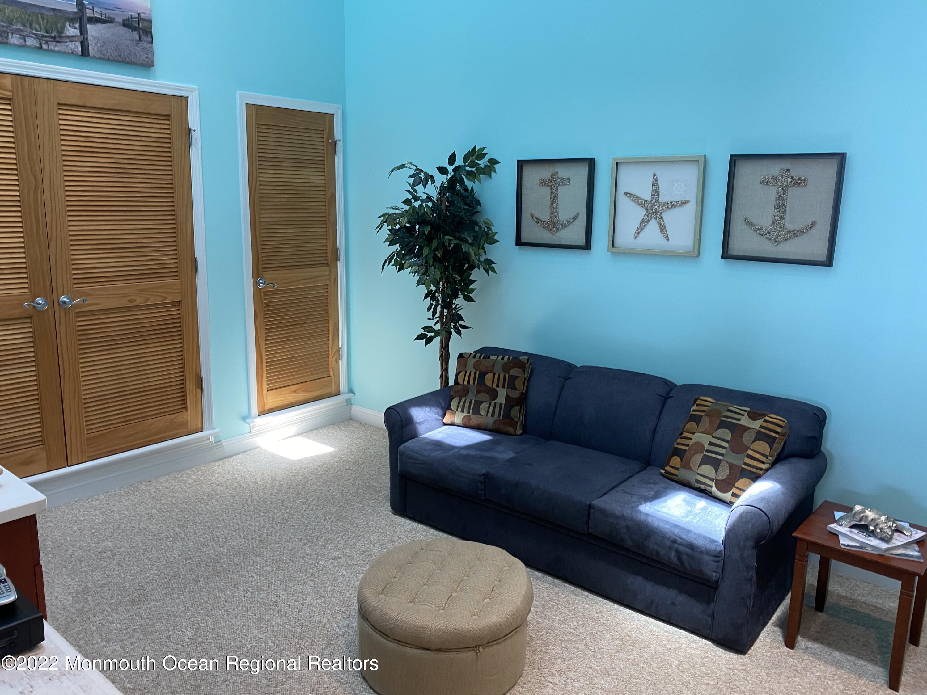 15 Sumner Avenue, Unit 12 Seaside Heights, NJ 08751 - Photo 11 of 24 a living room with furniture and a potted plant