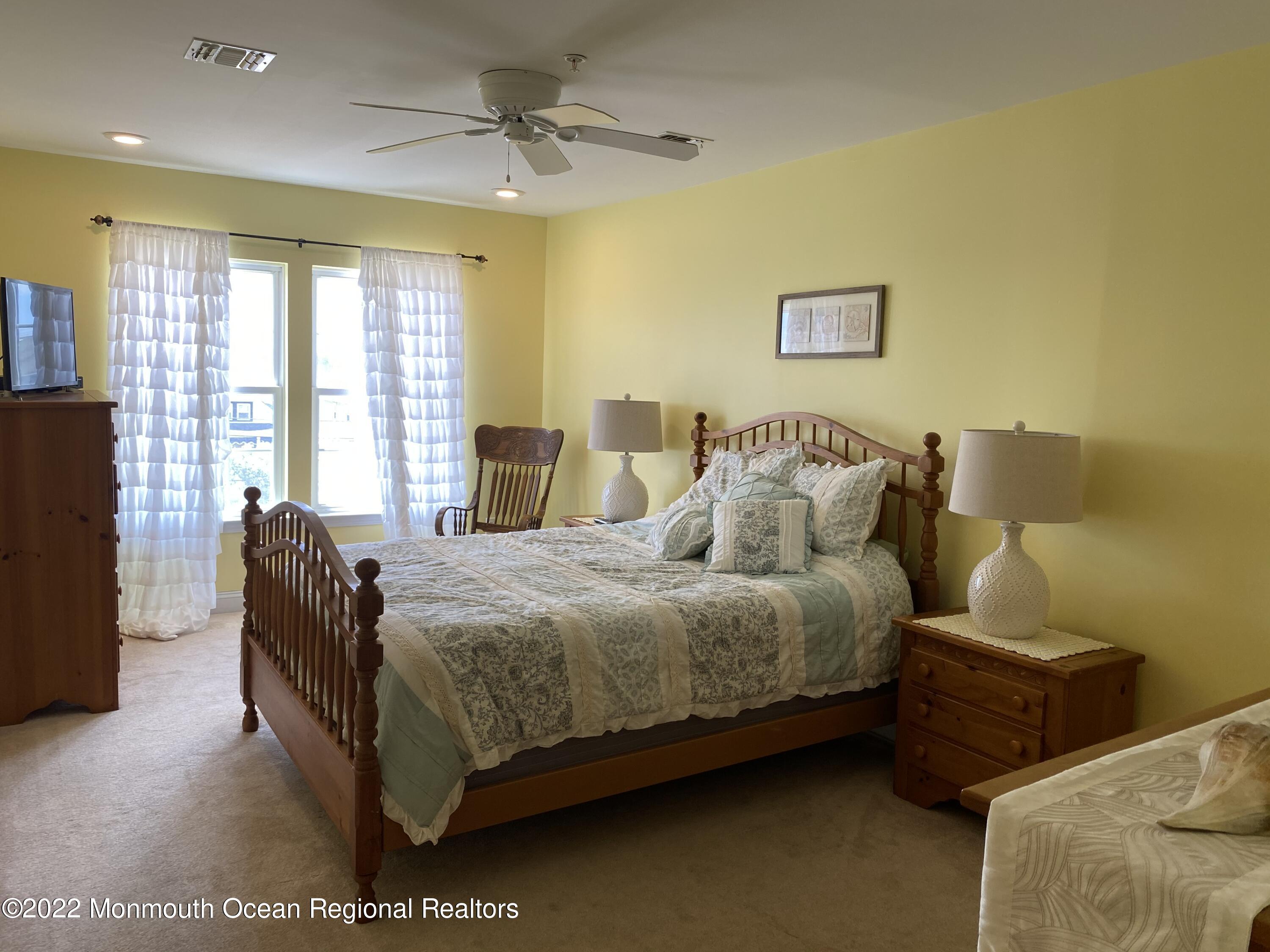 15 Sumner Avenue, Unit 12 Seaside Heights, NJ 08751 - Photo 15 of 24 a bedroom with a bed and wooden floor