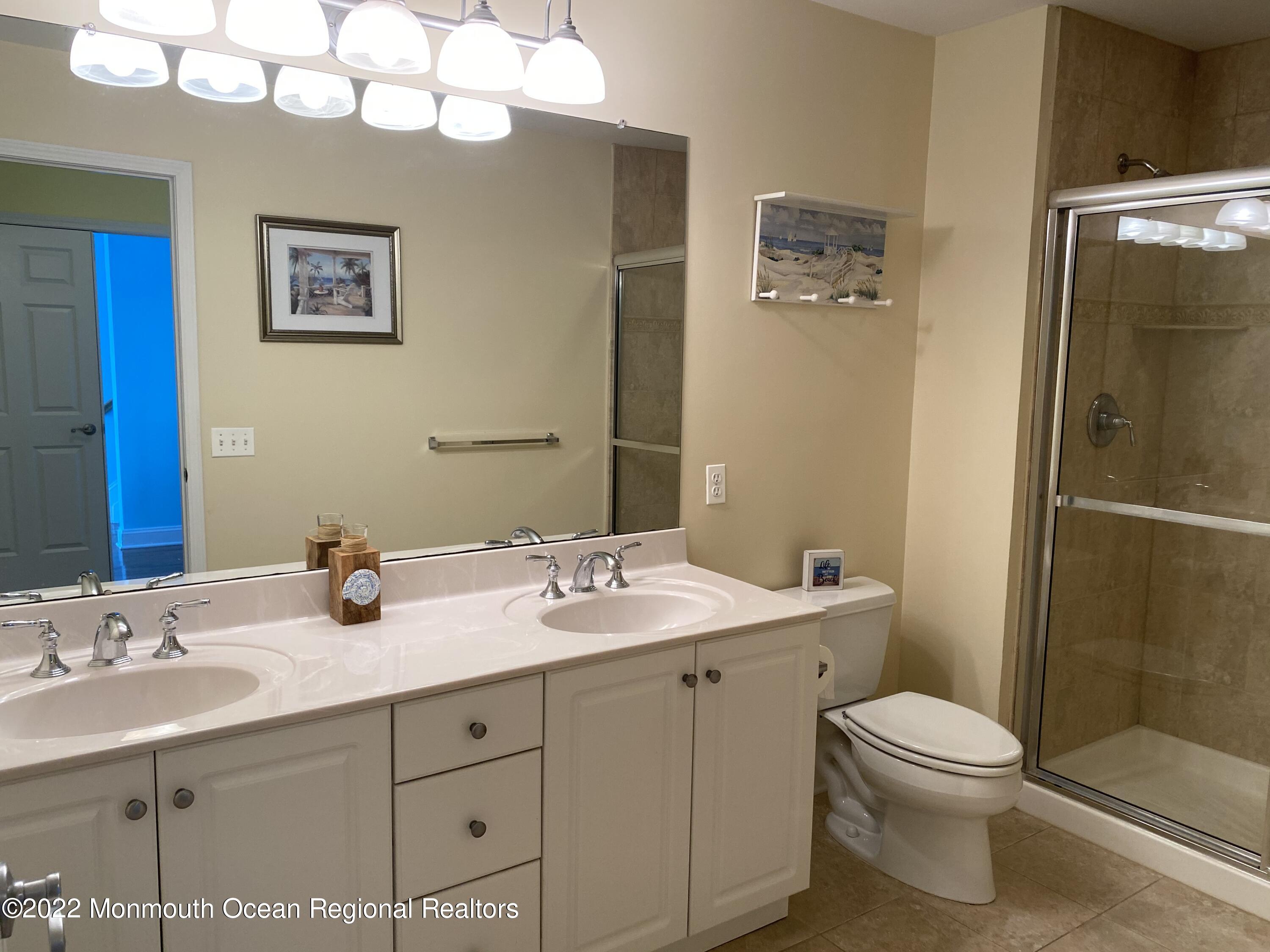 15 Sumner Avenue, Unit 12 Seaside Heights, NJ 08751 - Photo 16 of 24 a bathroom with a double vanity sink mirror and toilet