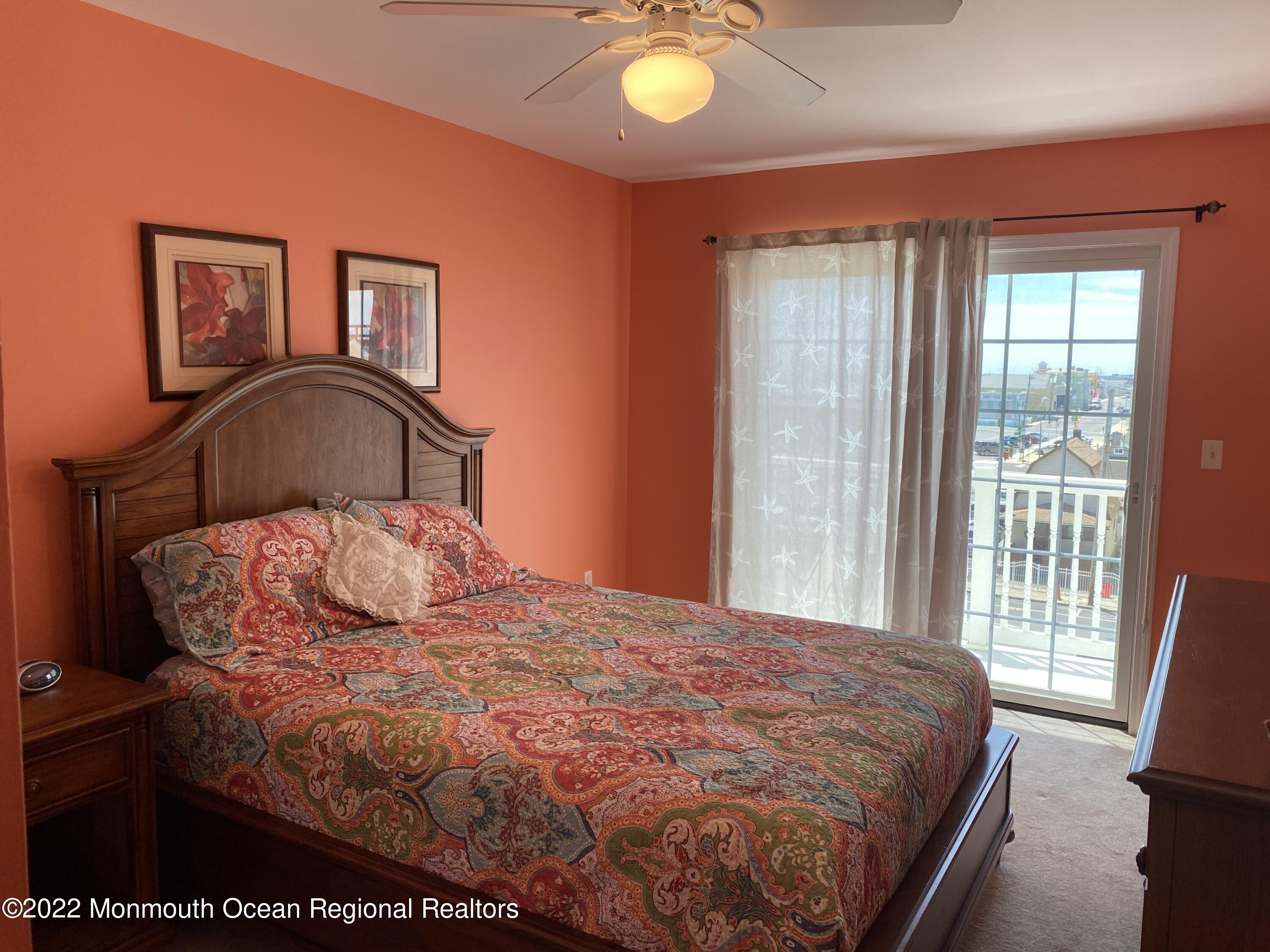 15 Sumner Avenue, Unit 12 Seaside Heights, NJ 08751 - Photo 19 of 24 a bedroom with a bed and glass window
