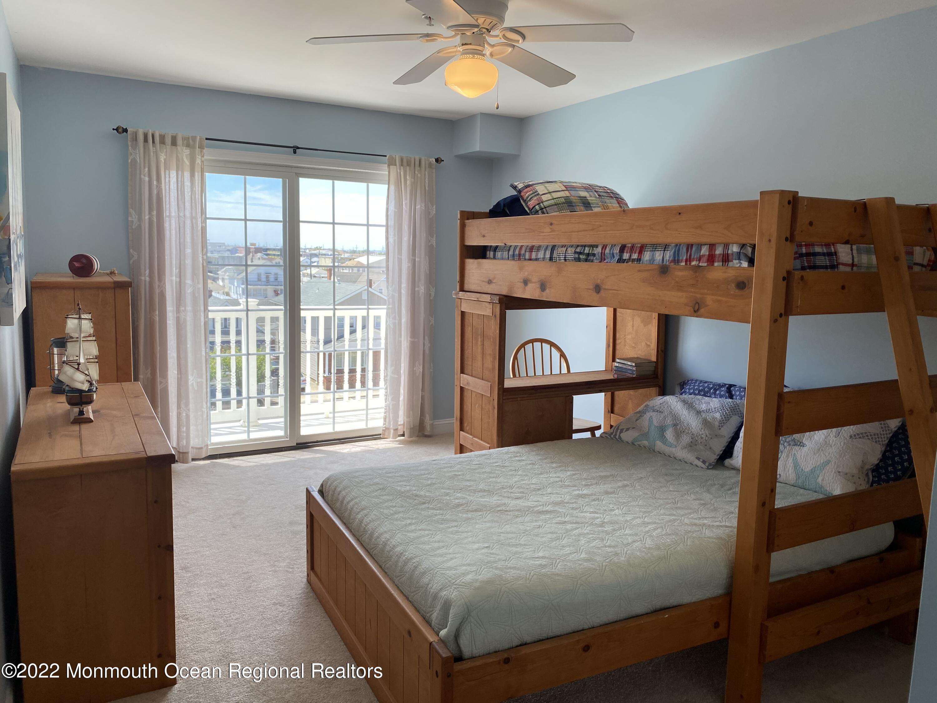 15 Sumner Avenue, Unit 12 Seaside Heights, NJ 08751 - Photo 20 of 24 a bedroom with a bed and a large window
