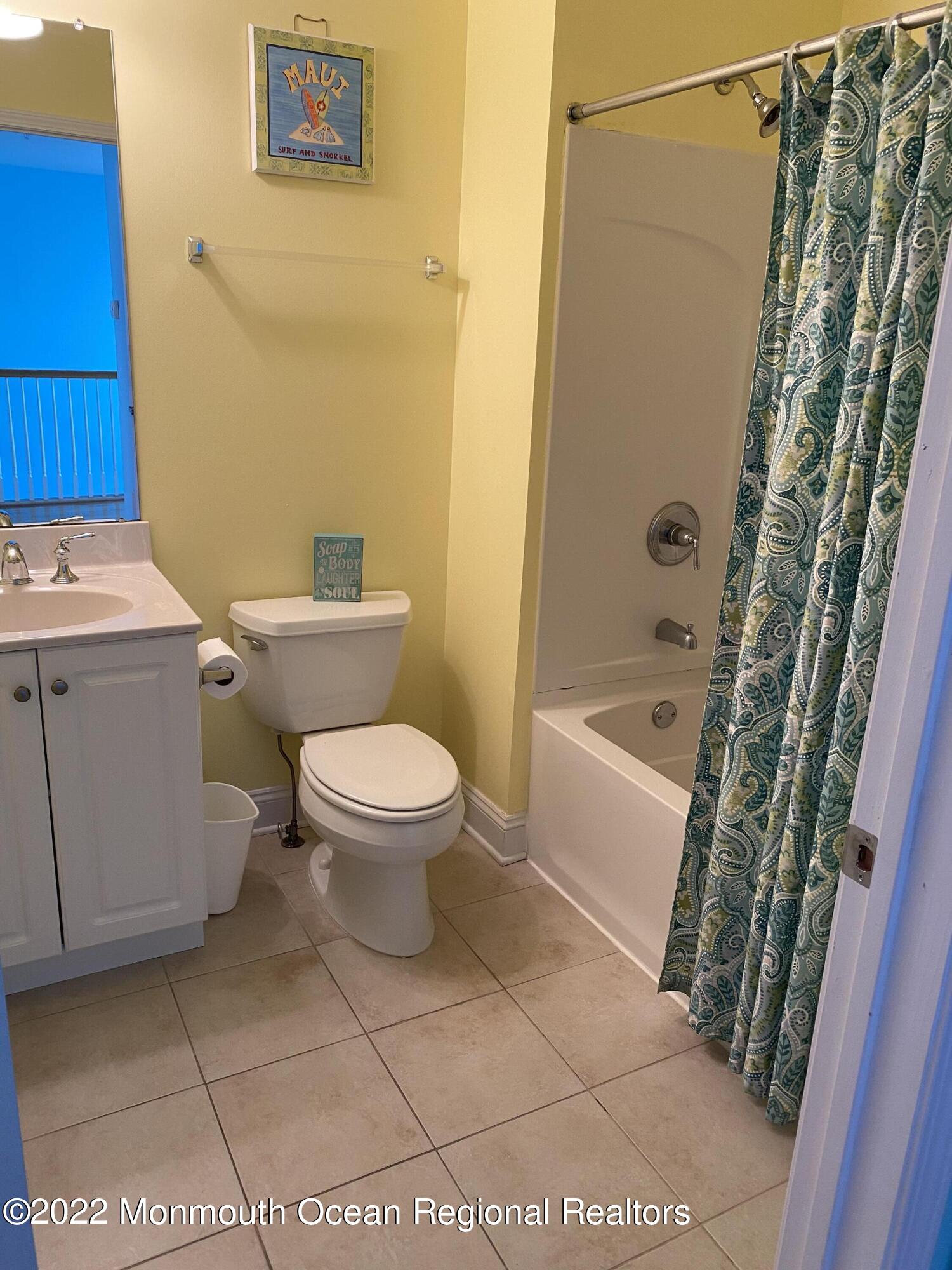 15 Sumner Avenue, Unit 12 Seaside Heights, NJ 08751 - Photo 21 of 24 a white toilet sitting next to a bath tub
