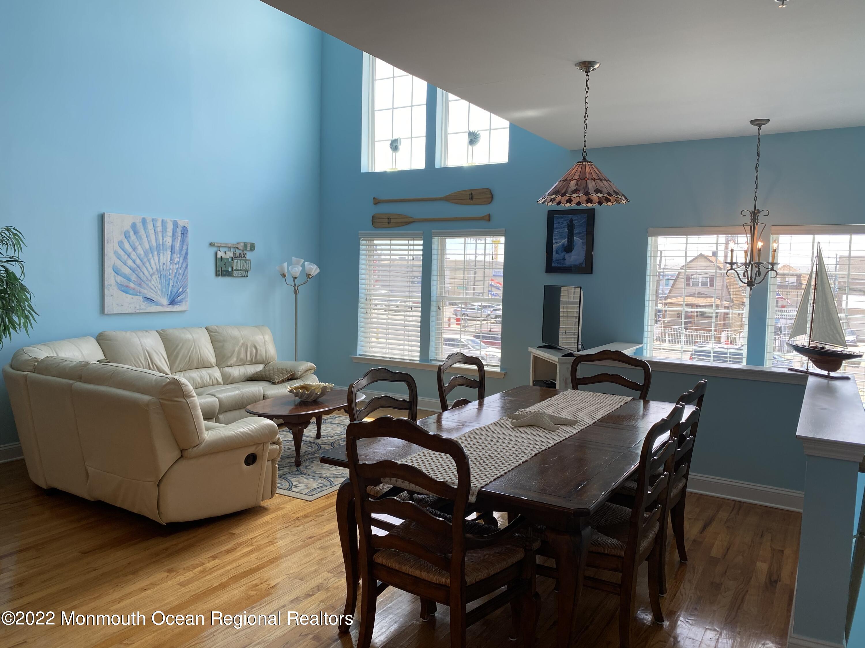 15 Sumner Avenue, Unit 12 Seaside Heights, NJ 08751 - Photo 6 of 24 a living room with furniture a window and a chandelier
