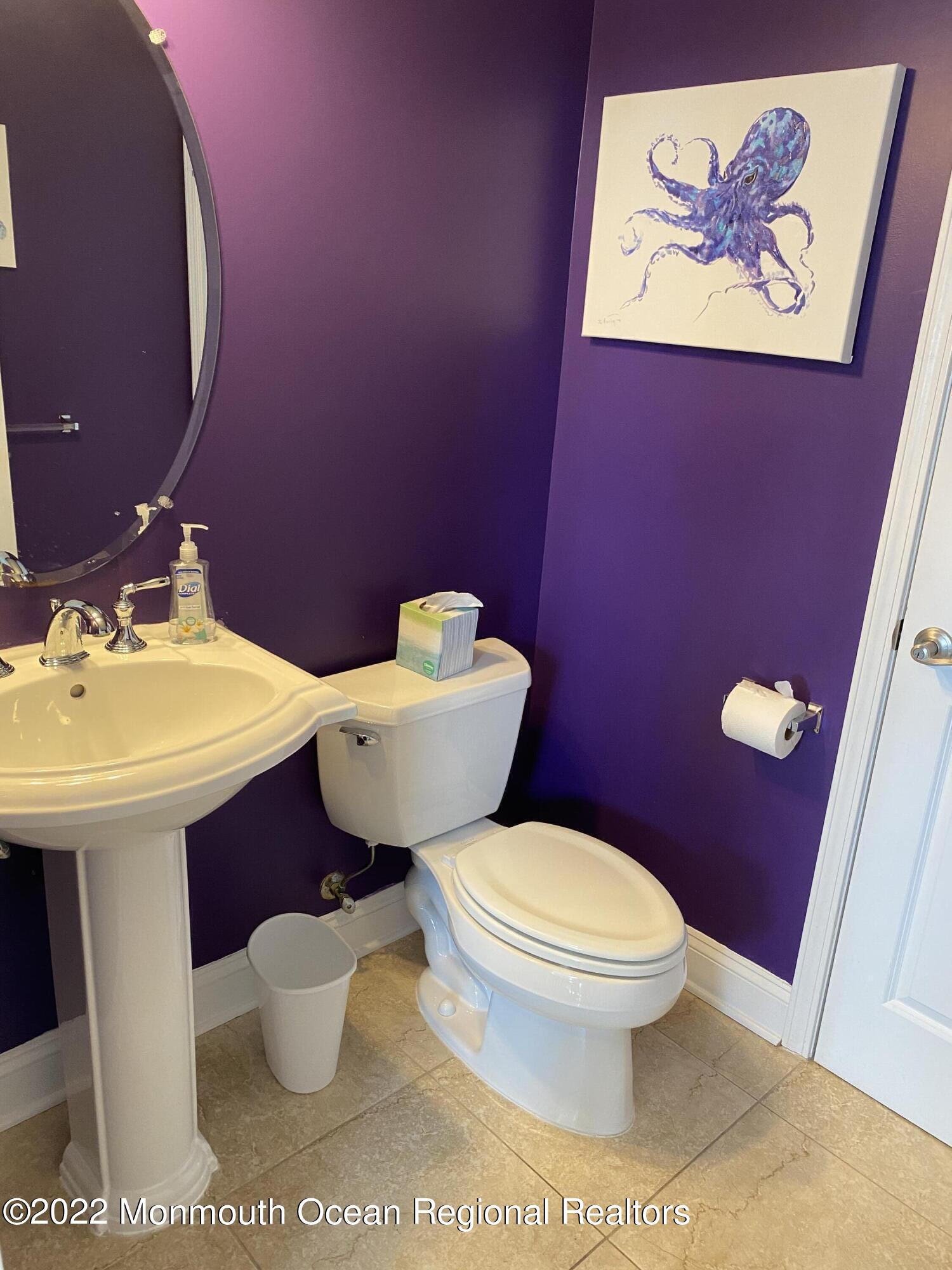 15 Sumner Avenue, Unit 12 Seaside Heights, NJ 08751 - Photo 10 of 24 a bathroom with a toilet a sink and mirror
