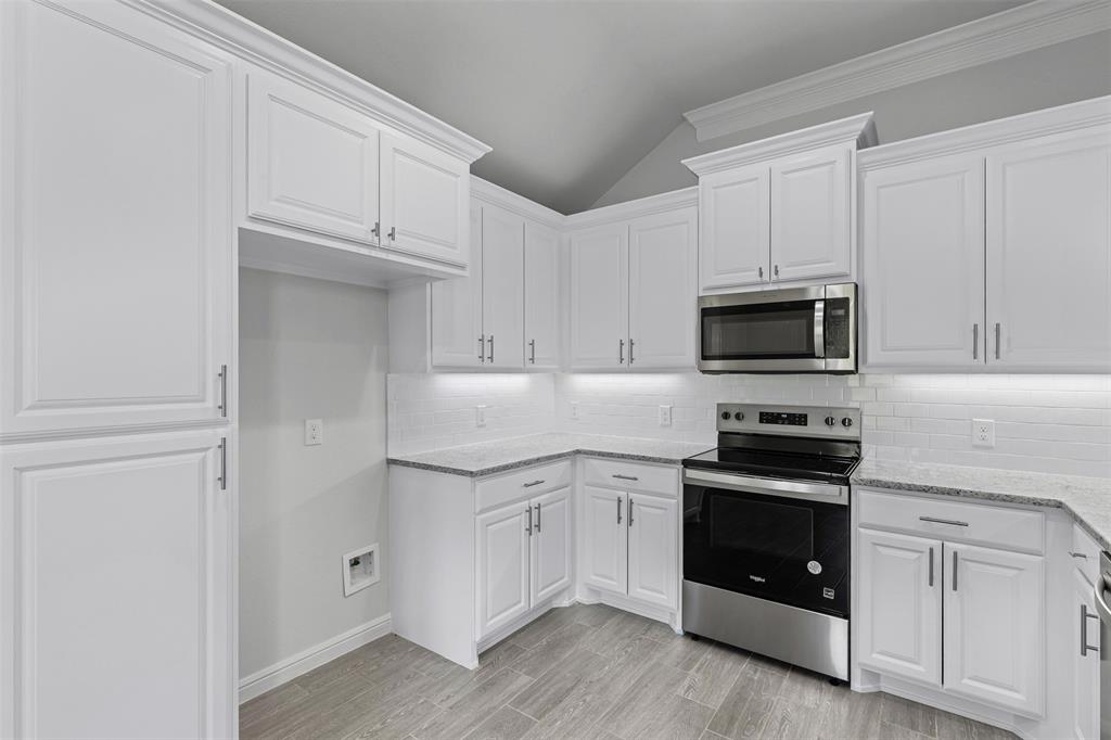 624 Jameson Springtown, TX 76082 - Photo 12 of 40 a kitchen with white cabinets and stainless steel appliances