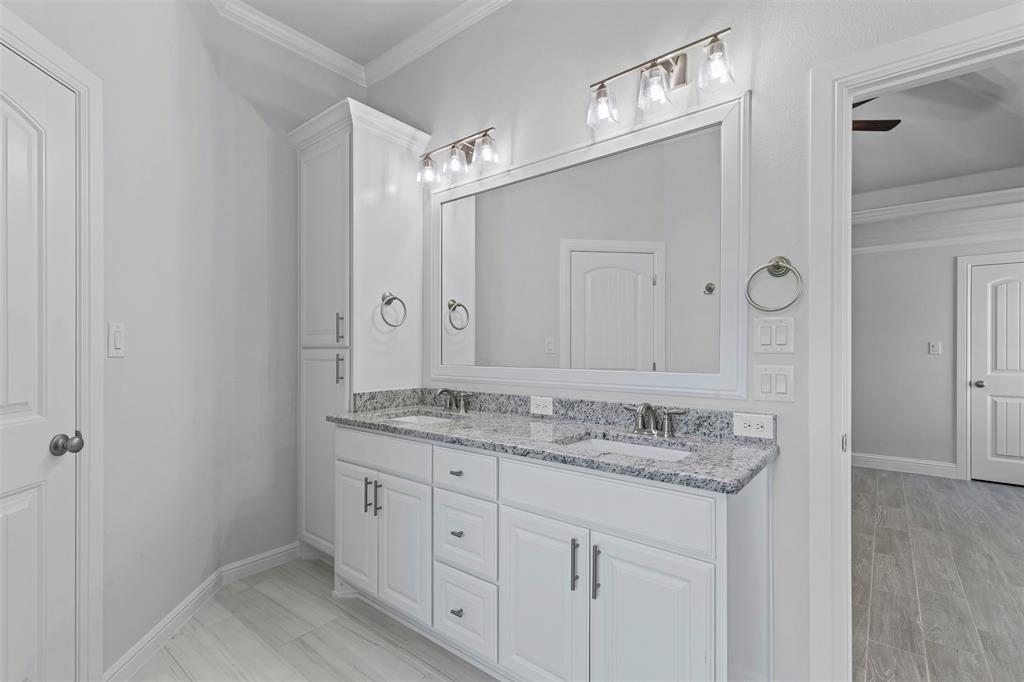 624 Jameson Springtown, TX 76082 - Photo 21 of 40 a bathroom with a granite countertop sink and a mirror