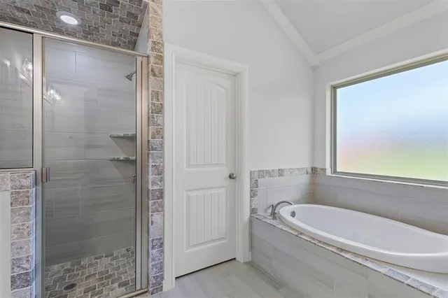 a bathroom with a bathtub and shower