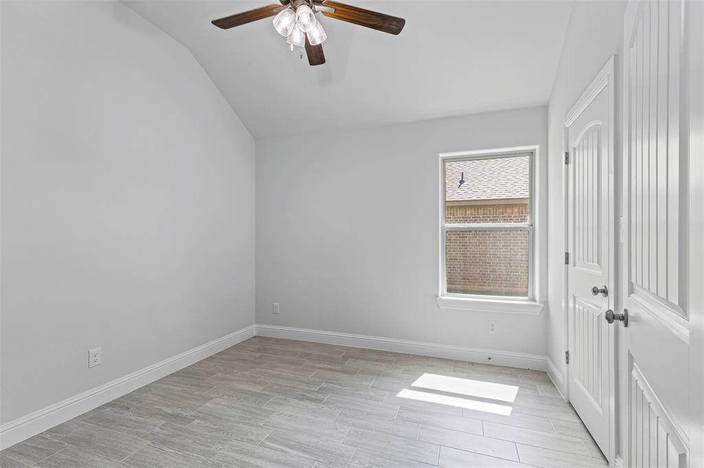 624 Jameson Springtown, TX 76082 - Photo 24 of 40 an empty room with windows and chandelier fan