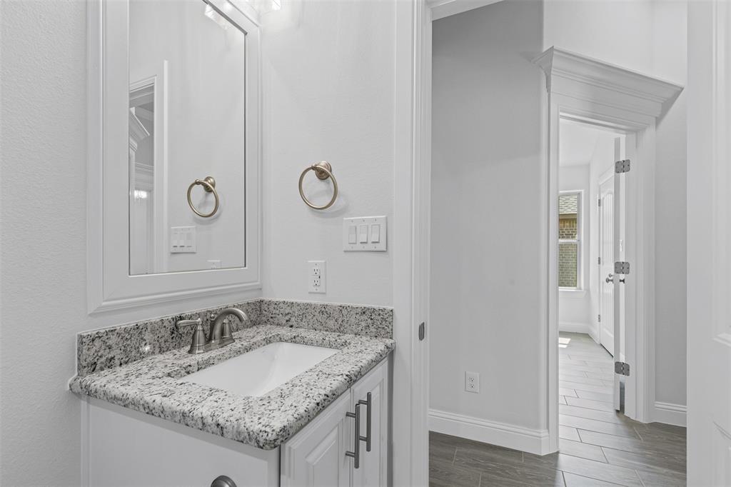 624 Jameson Springtown, TX 76082 - Photo 27 of 40 a bathroom with a granite countertop sink and a mirror