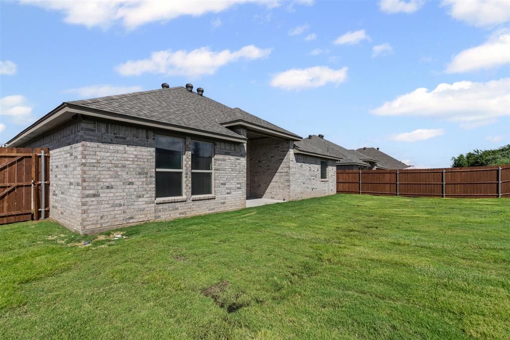 624 Jameson Springtown, TX 76082 - Photo 33 of 40 a view of a house with a yard