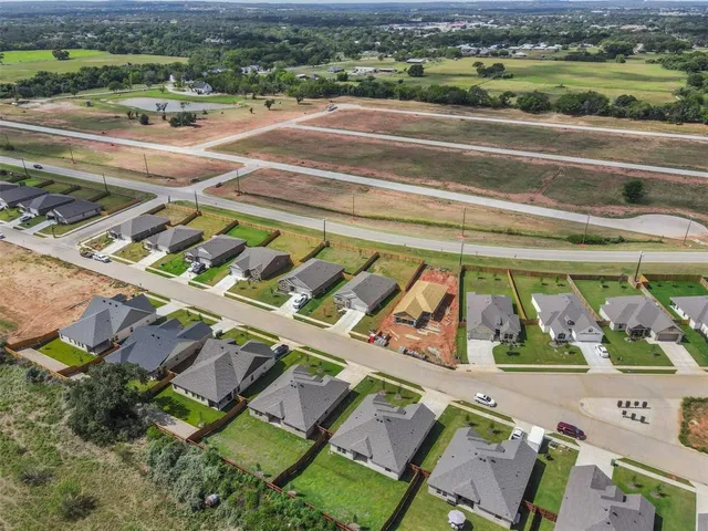 an aerial view of a residential houses with outdoor space