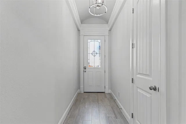a view of a hallway with wooden floor