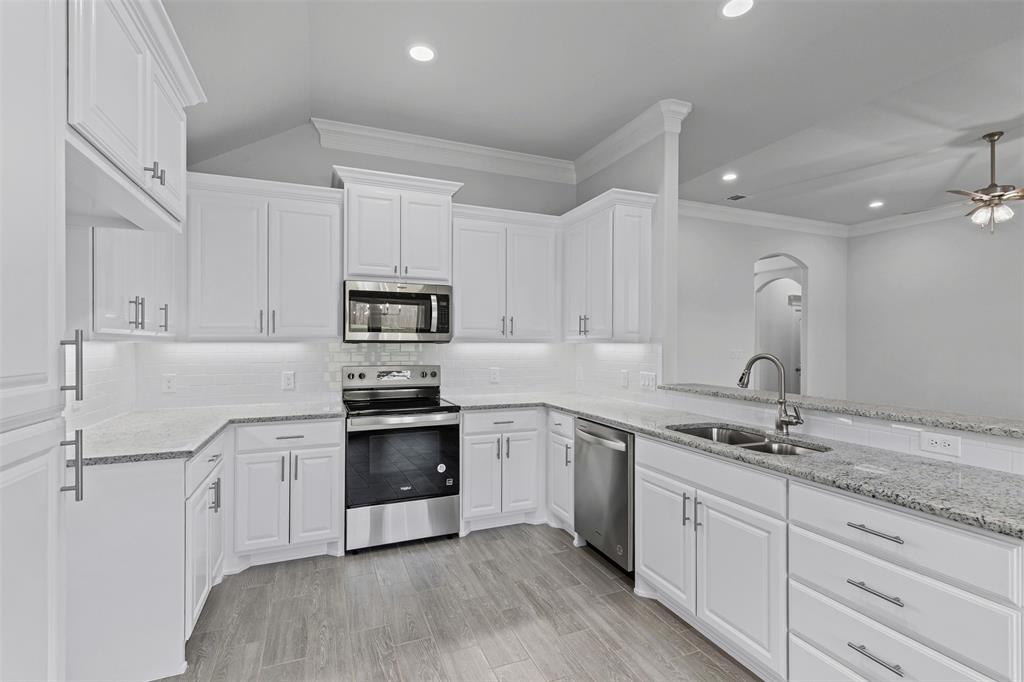 624 Jameson Springtown, TX 76082 - Photo 10 of 40 a kitchen with granite countertop white cabinets and stainless steel appliances