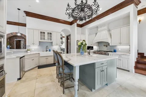 a dining room with furniture a chandelier and window