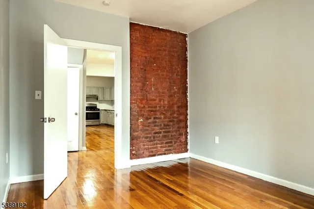 a view of hallway with wooden floor