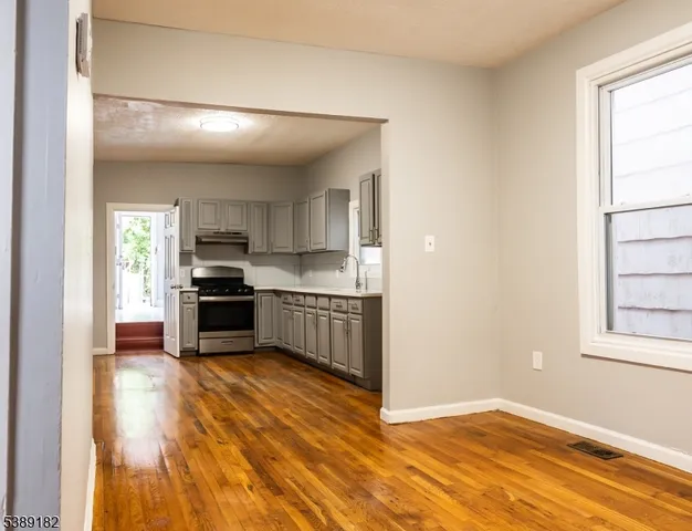 a kitchen with a refrigerator and a stove top oven
