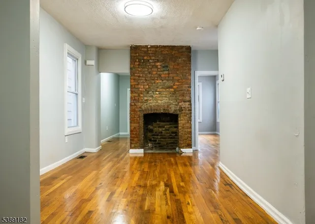 a view of an empty room and fire place