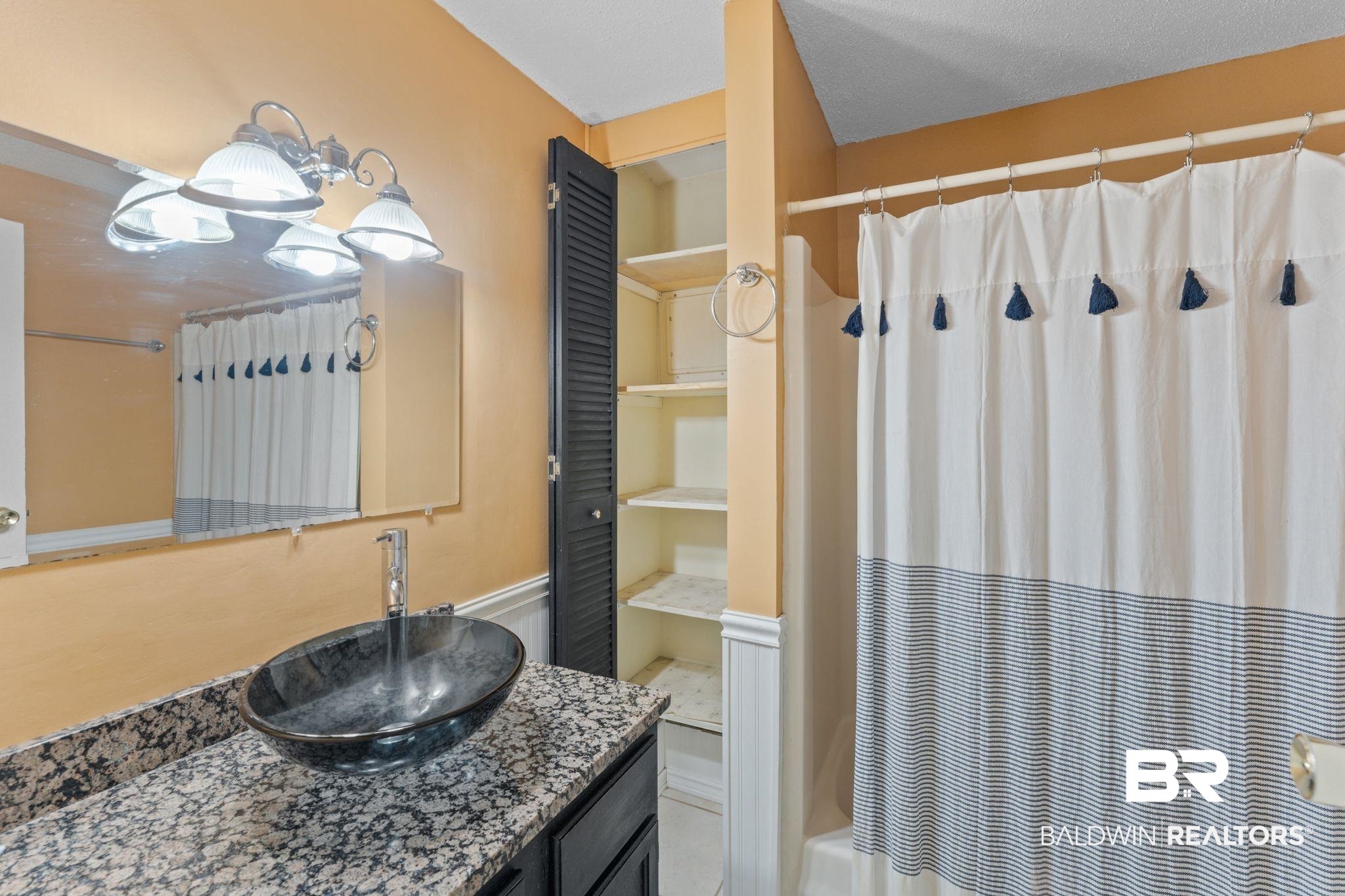 14095 Riverside Drive Foley, AL 36535 - Photo 20 of 30 Bathroom with vanity and shower / bathtub combination with curtain