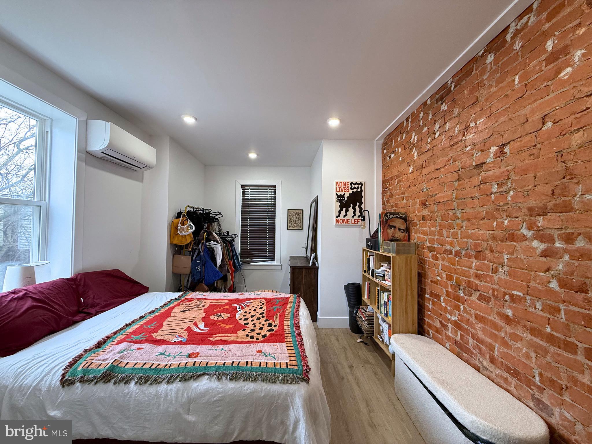 6136 Chancellor Street Philadelphia, PA 19139 - Photo 7 of 10 a bedroom with a bed and a flat tv screen on dresser