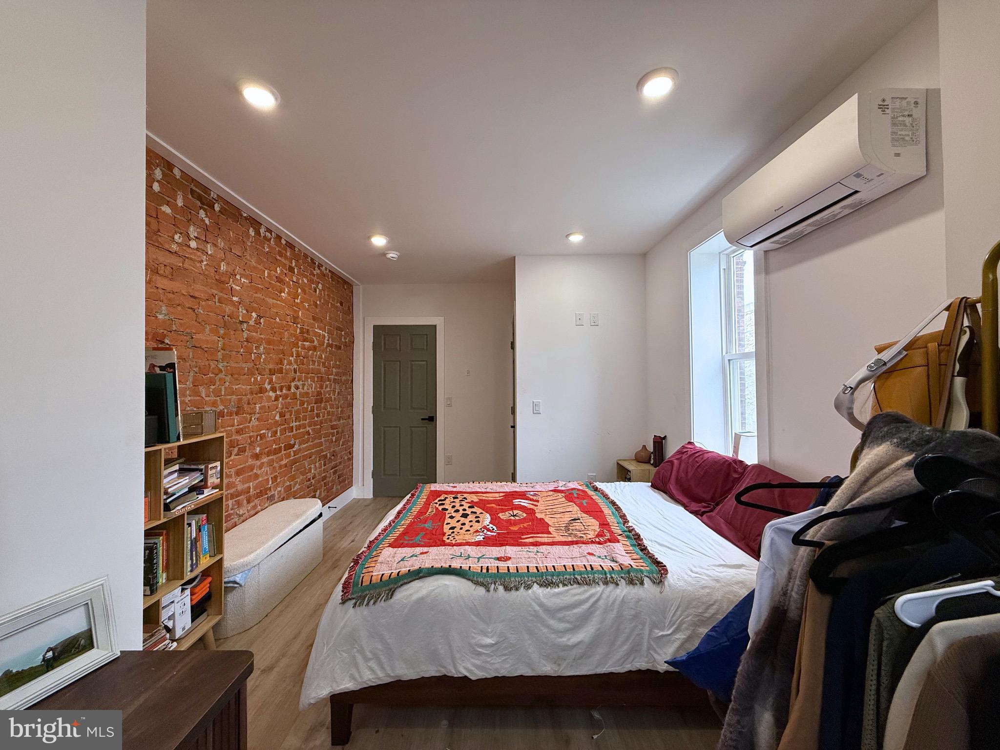 6136 Chancellor Street Philadelphia, PA 19139 - Photo 8 of 10 a bedroom with a bed and a book shelf