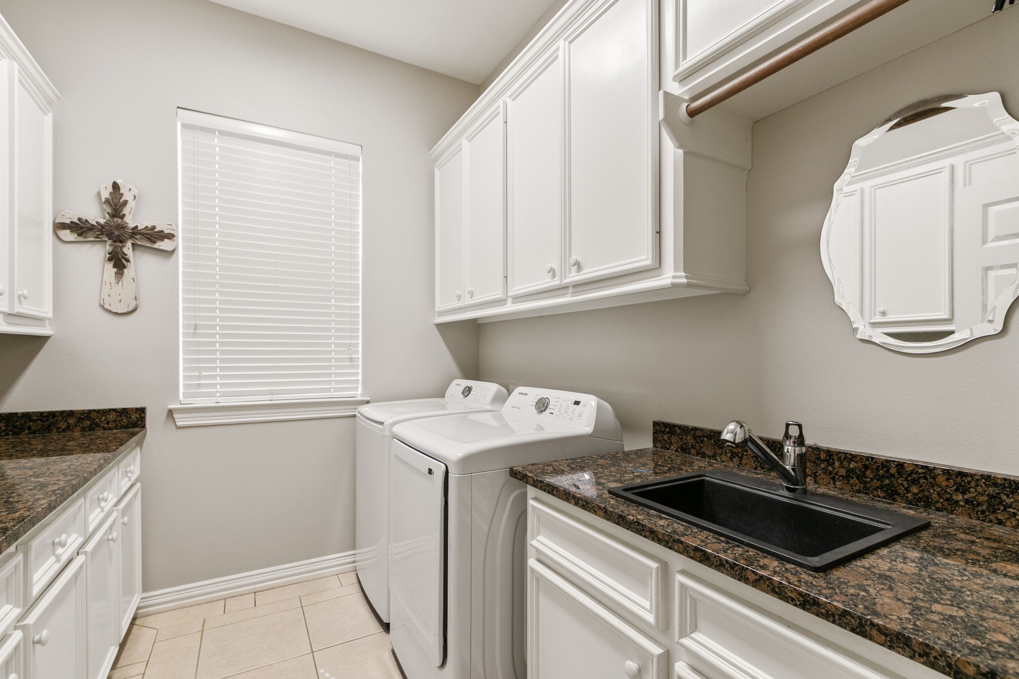 5803 Desert Oak Way Spring, TX 77379 - Photo 21 of 50 Huge laundry room with an abundance of cabinets, sink, folding counter and hanging rack.