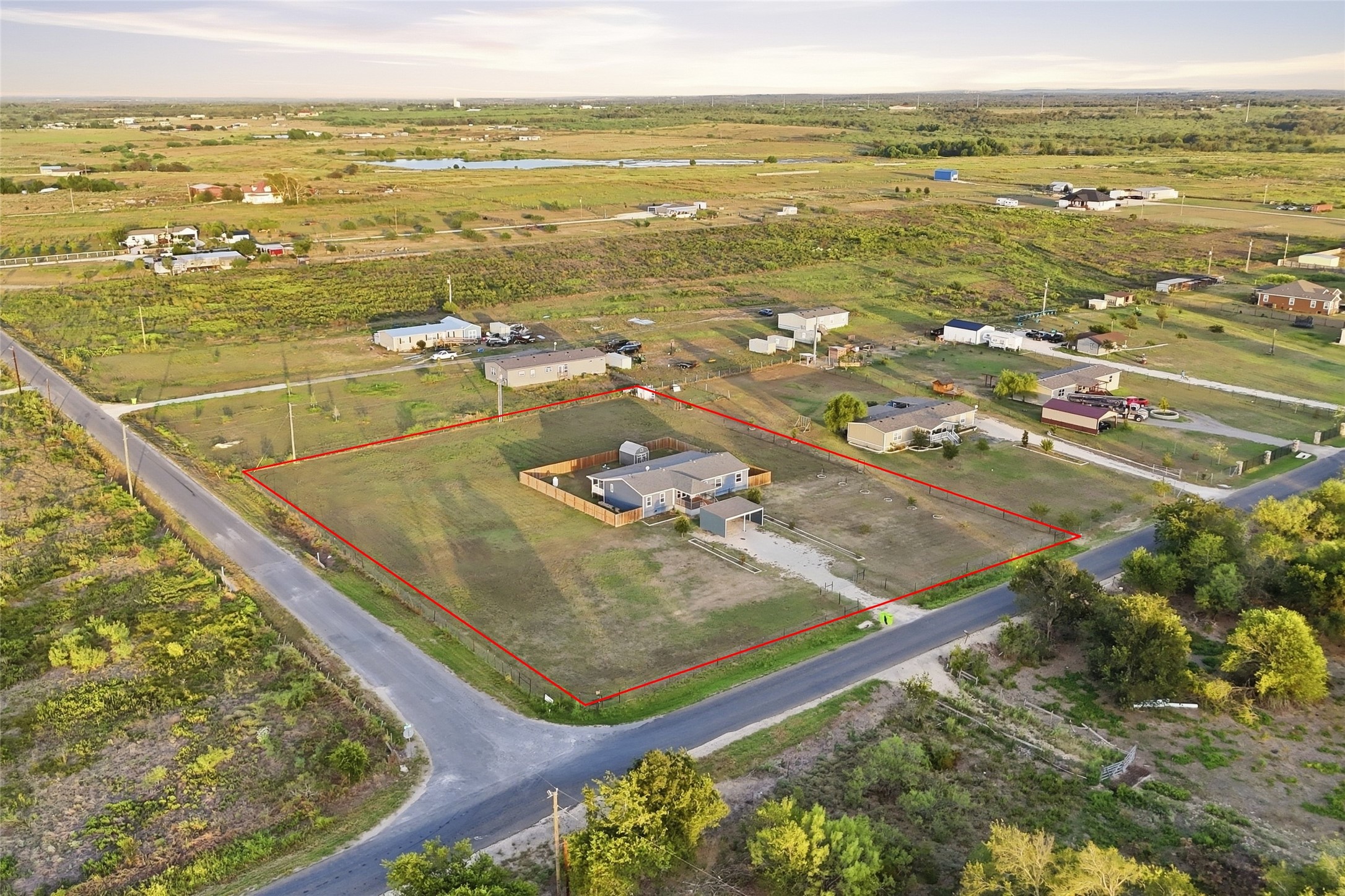 2709 County Road 463 Elgin, TX 78621 - Photo 25 of 32 A spacious rural property sits enclosed by fencing under a vast Texas sky.