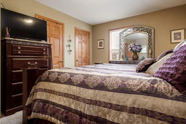a bedroom with a bed and a dresser