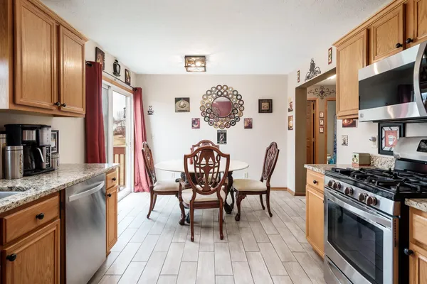 a bedroom with a bed and dresser with mirror