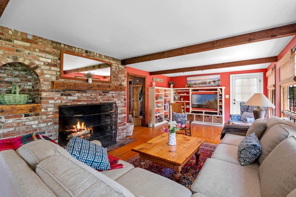 3 E Road Marblehead, MA 01945 - Photo 7 of 17 a living room with furniture a fireplace and a floor to ceiling window